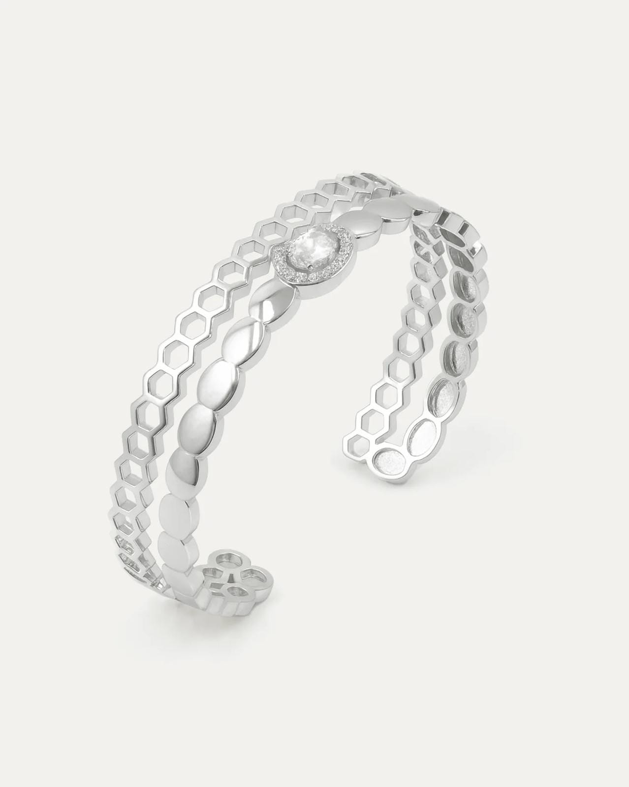 Silver openwork ring on a light gray background