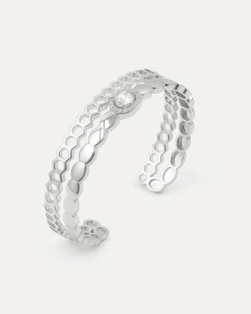 Silver openwork ring on a light gray background