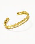 Gold bracelet with a honeycomb pattern on a white background
