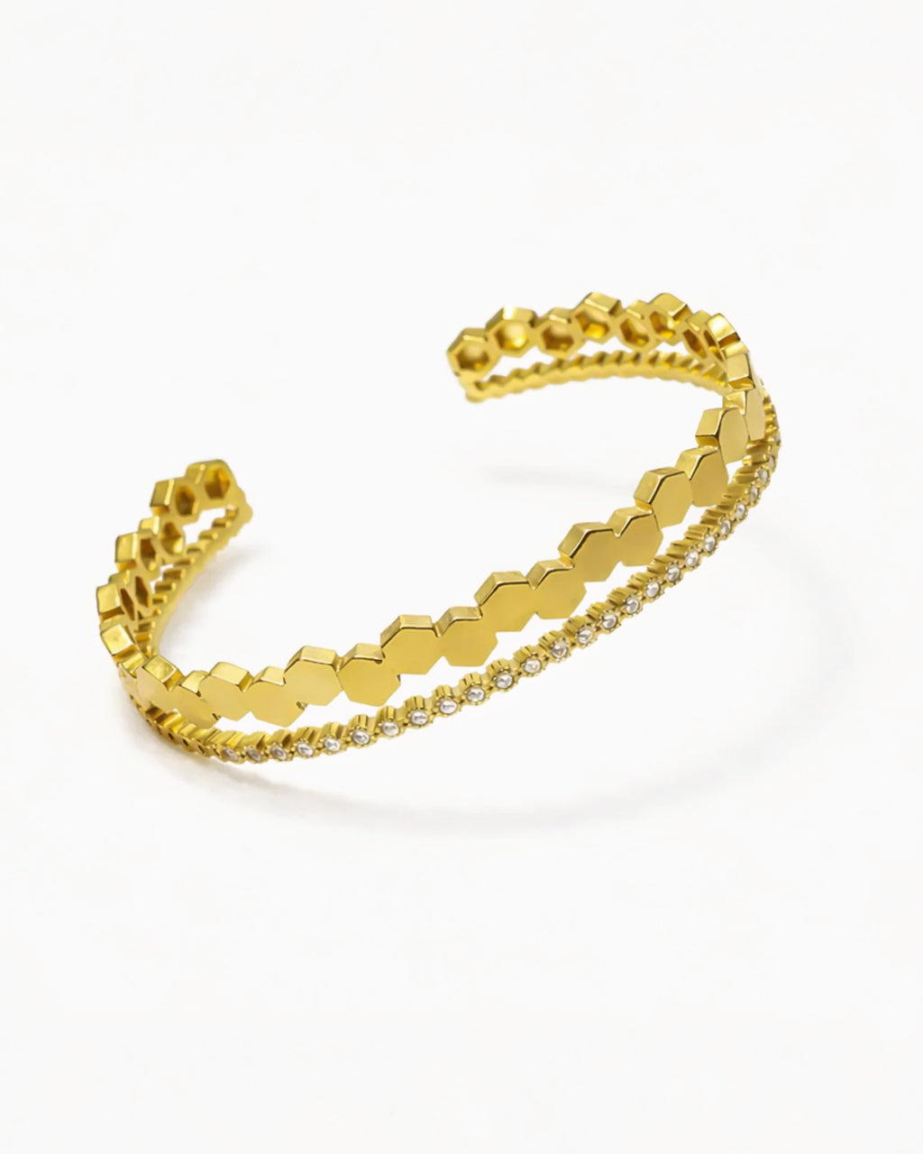 Gold bracelet with a honeycomb pattern on a white background
