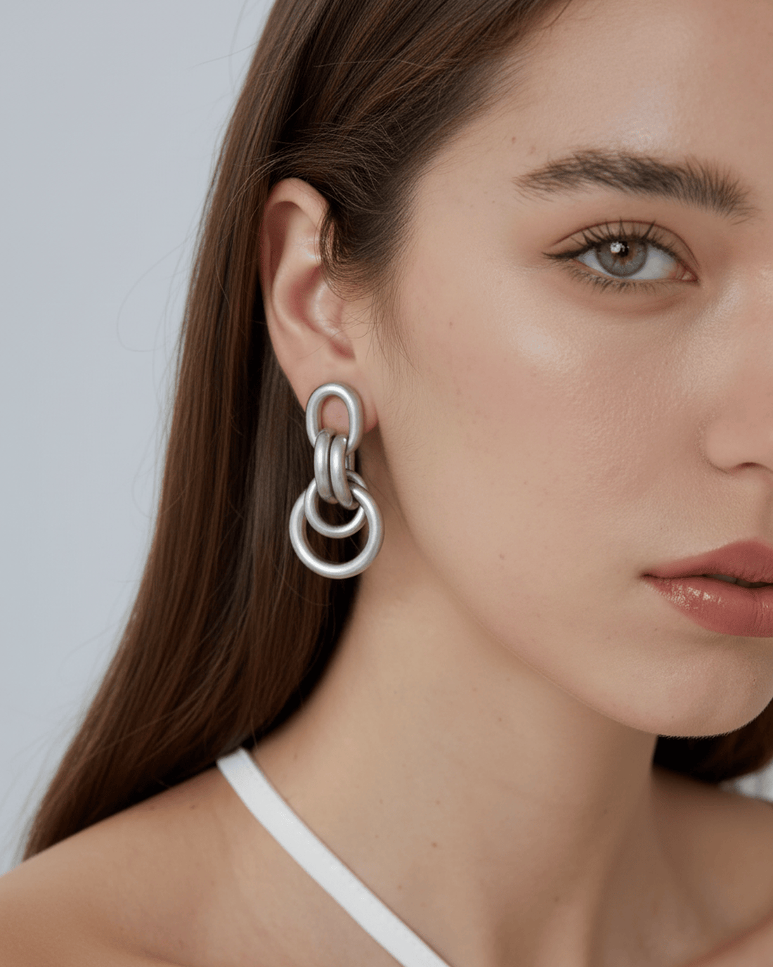 Pair of silver chain-link earrings on a white background