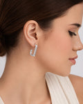 silver-plated J-shape hoop earrings worn on model, modern minimalist drop earring design
