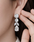 Lumière Cascade water drop earrings worn on ear in silver plated cubic zirconia