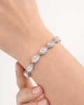 Lumière drop tennis bracelet on wrist with clear zircon stones, silver plated