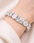 Oval CZ tennis bracelet in silver plated finish, worn on wrist lifestyle view