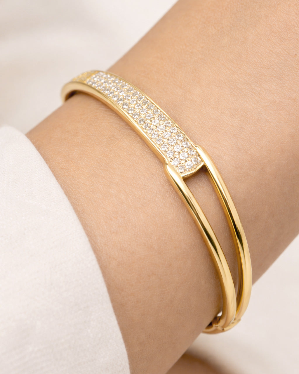 Close-up on wrist gold-plated pavé crystal bangle bracelet for women 