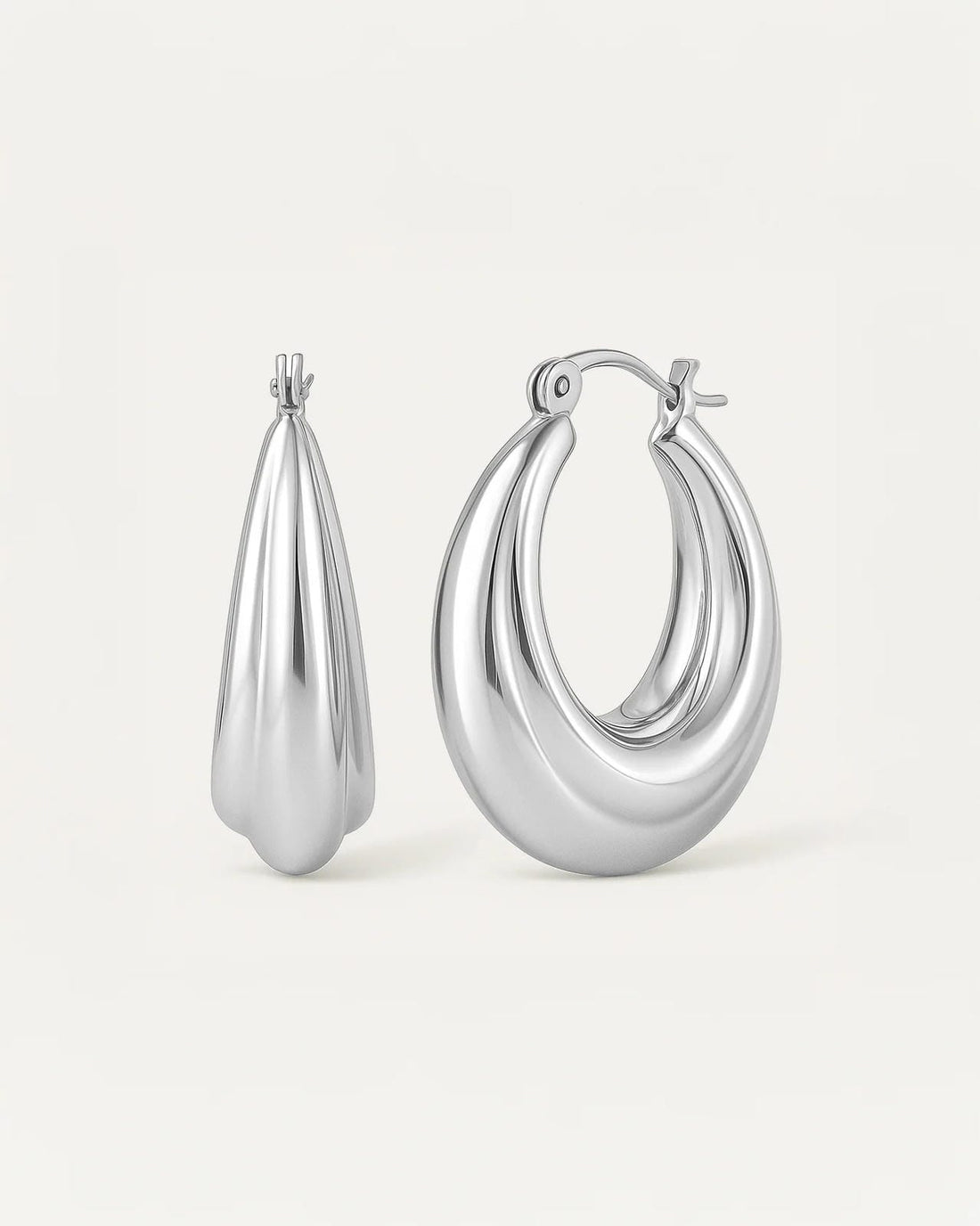silver-plated luna curve hoop earrings, smooth sculptural crescent design with polished finish