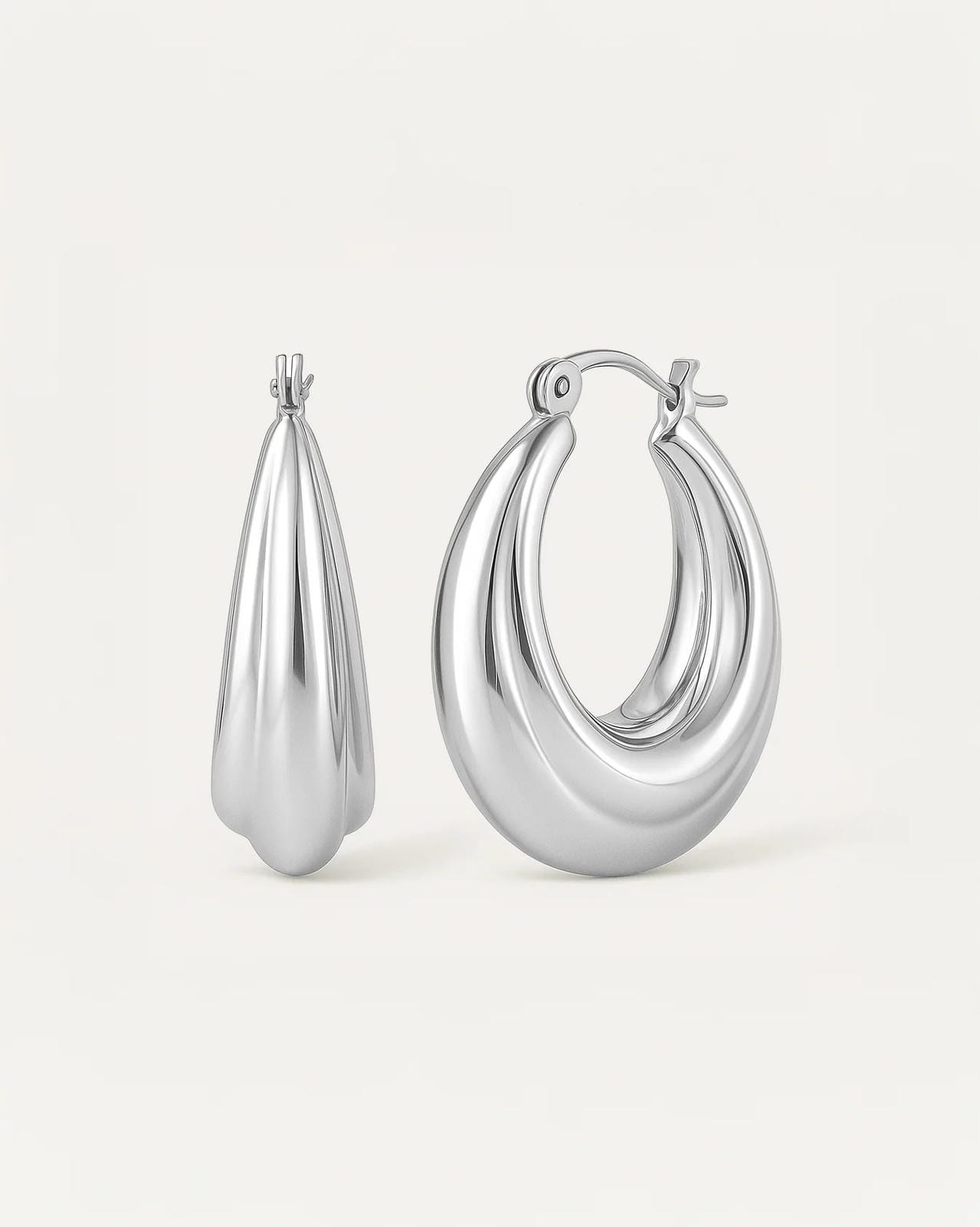 silver-plated luna curve hoop earrings, smooth sculptural crescent design with polished finish