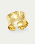 Elegant wide hammered gold cuff bracelet with reflective finish, crafted in 18K gold-plated brass. Features sculpted wavy tex