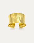 Elegant wide hammered gold cuff bracelet with reflective finish, crafted in 18K gold-plated brass. Features sculpted wavy tex