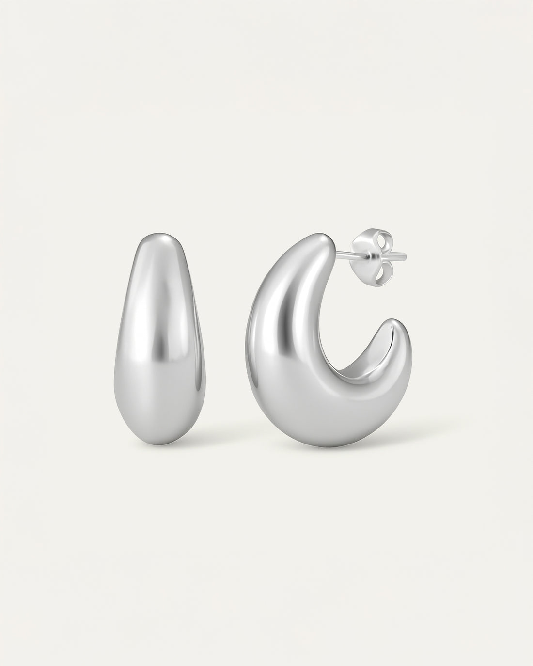 Pair of silver hoop earrings on a light gray background