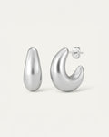 Pair of silver hoop earrings on a light gray background