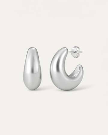 Pair of silver hoop earrings on a light gray background