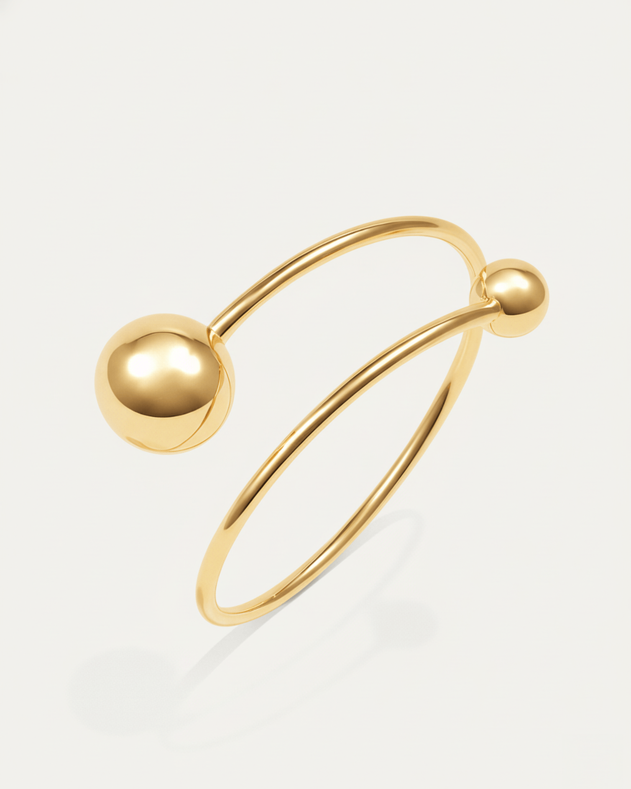 Orbit Dual Sphere Cuff – 18K gold-plated brass bracelet with two polished spheres, modern open cuff design.