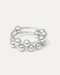 silver-plated sculptural ring with double bands and polished ball accents on white background