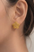 Close-up gold-plated bubble flower stud earrings with textured design