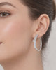 Silver star hoop earrings with crystal detail worn on ear minimalist style