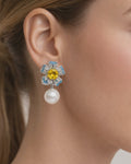 Jadejuri blue floral pearl drop earrings with yellow crystal, close-up view