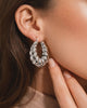 Silver chunky spiral hoop earrings worn on ear bold minimalist statement