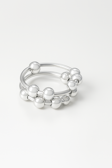 silver-plated sculptural ring with double bands and polished ball accents on white background