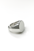 silver-plated signet ring with oval top and open band on white background
