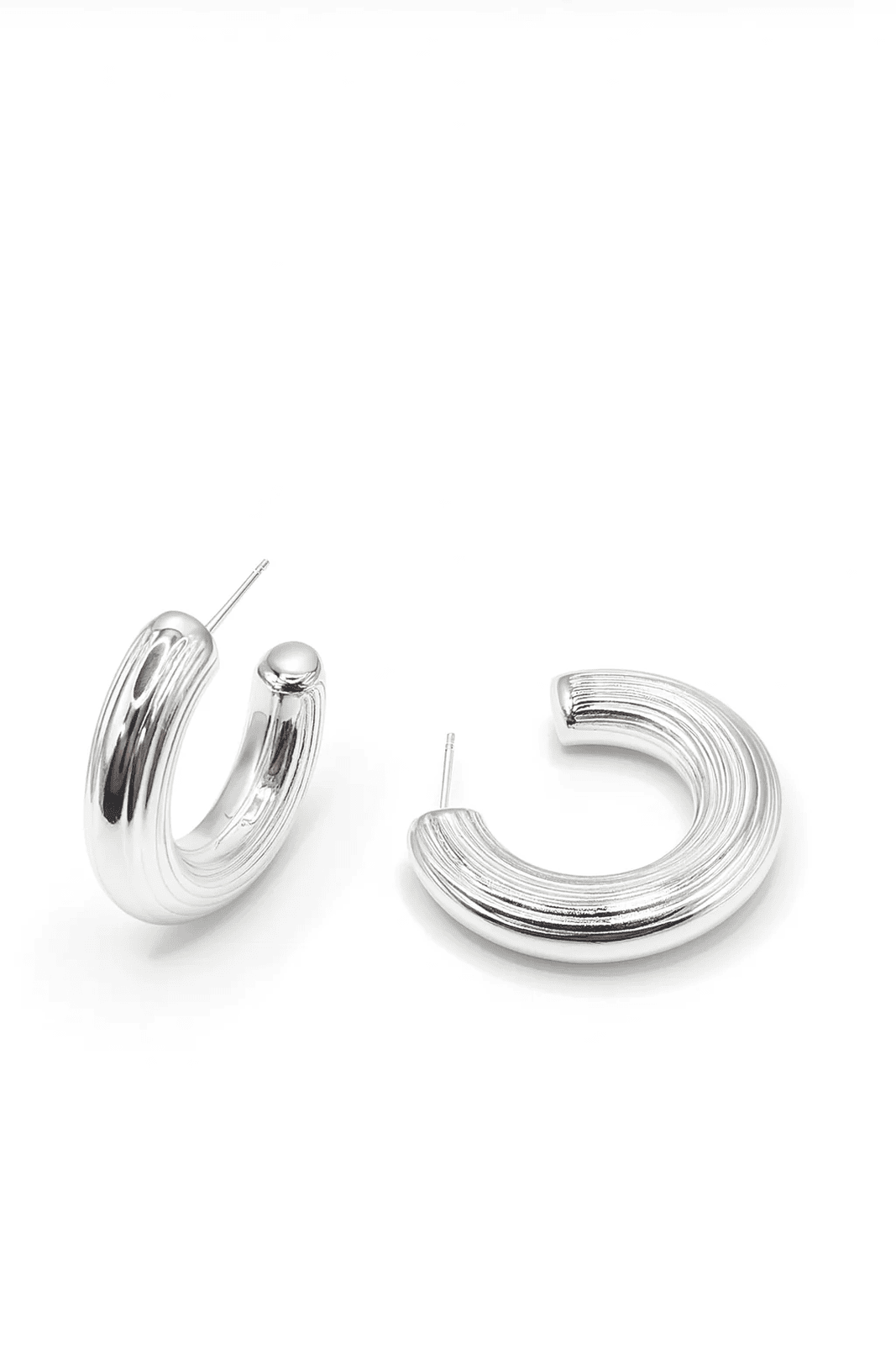 Silver hoop earrings on a light gray background