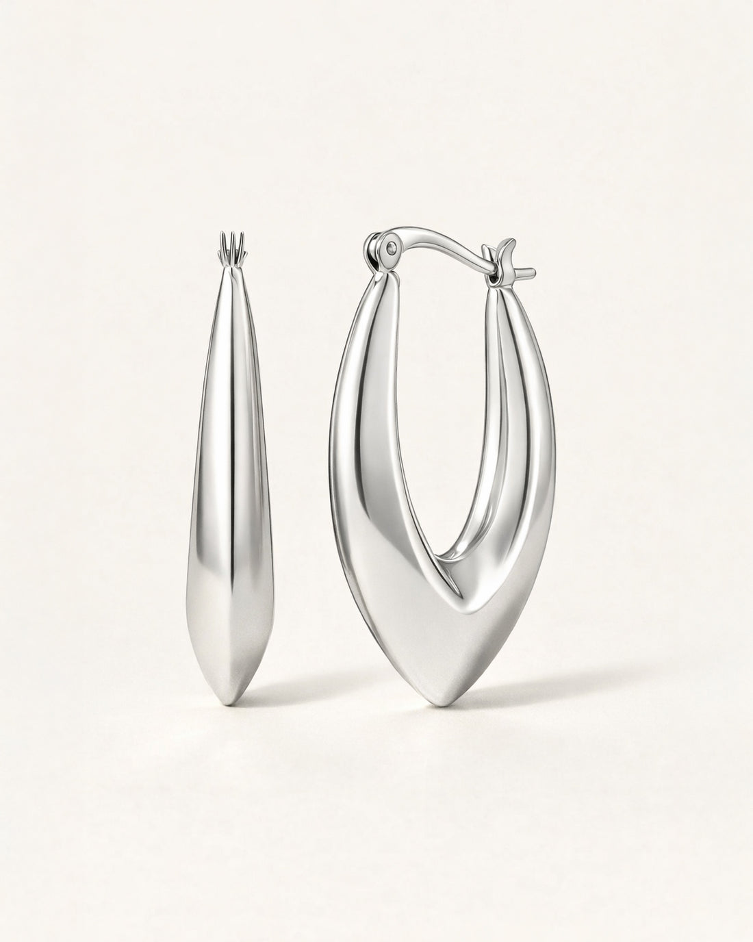 Silver sculpted marquise hoop earrings front view, featuring a polished minimalist design by Jadejuri