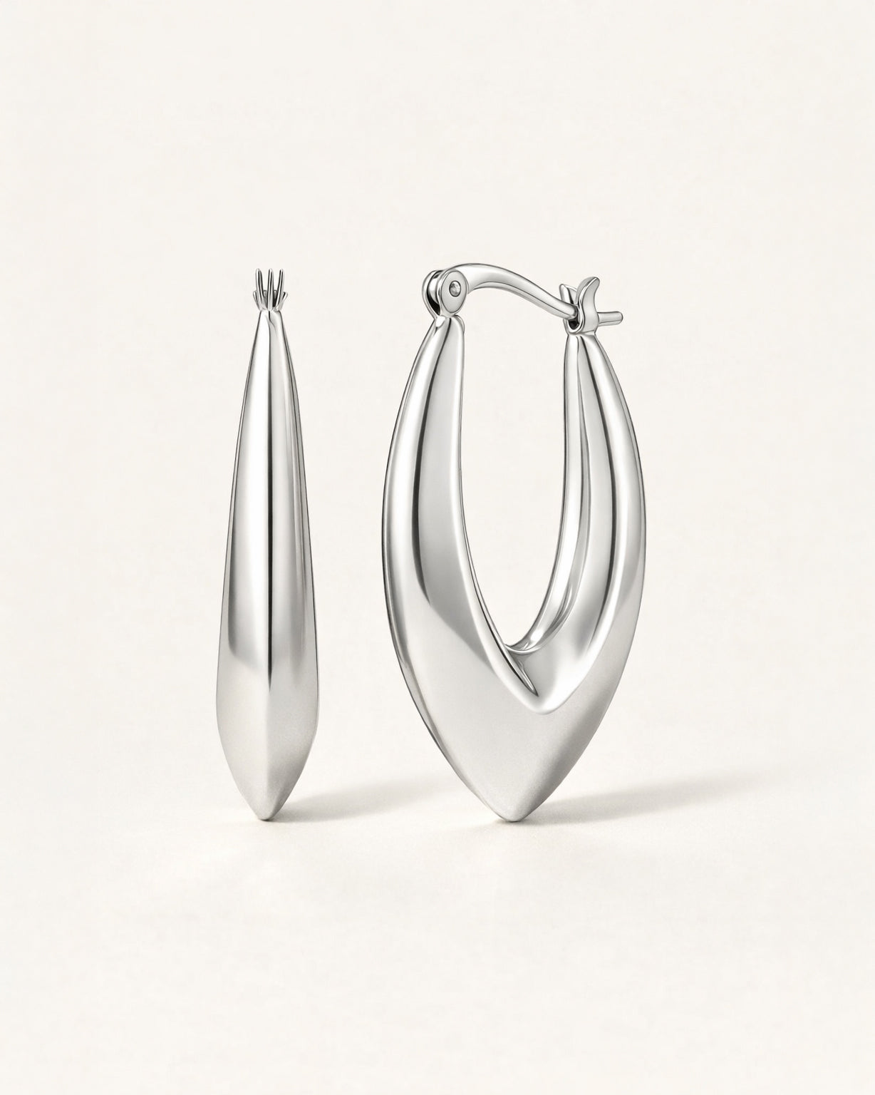 Silver sculpted marquise hoop earrings front view, featuring a polished minimalist design by Jadejuri