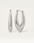 Close-up of sculpted silver hoop earrings in bold marquise teardrop shape with latch-back closure