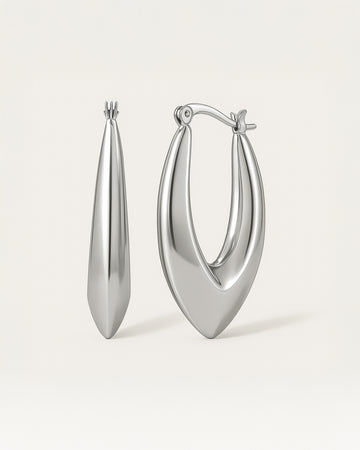 Close-up of sculpted silver hoop earrings in bold marquise teardrop shape with latch-back closure