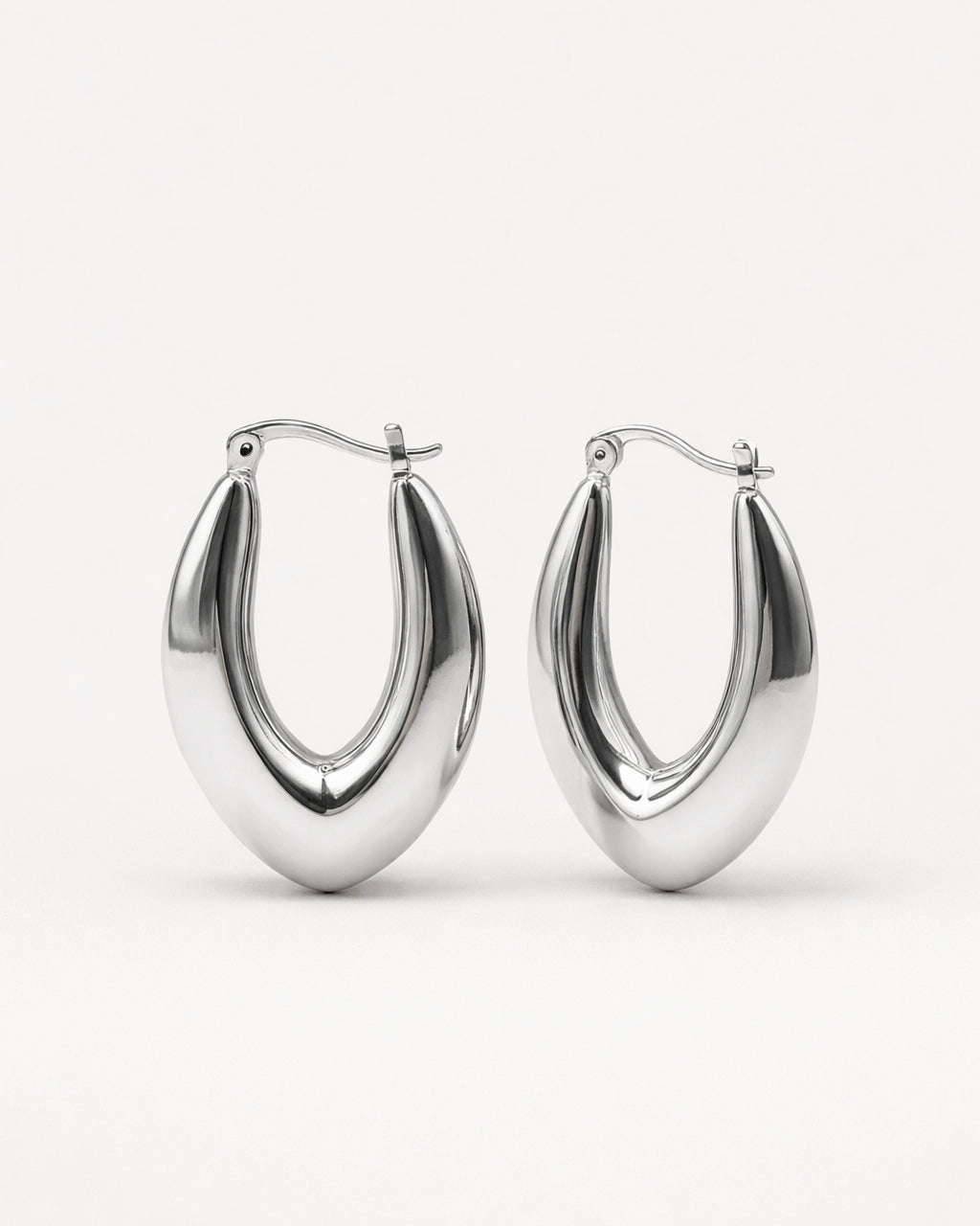 Silver sculpted marquise hoop earrings front view, featuring a polished minimalist design by Jadejuri