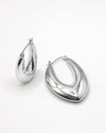 Silver sculpted hoop earrings top view, featuring a marquise-inspired shape and polished minimalist design by Jadejuri