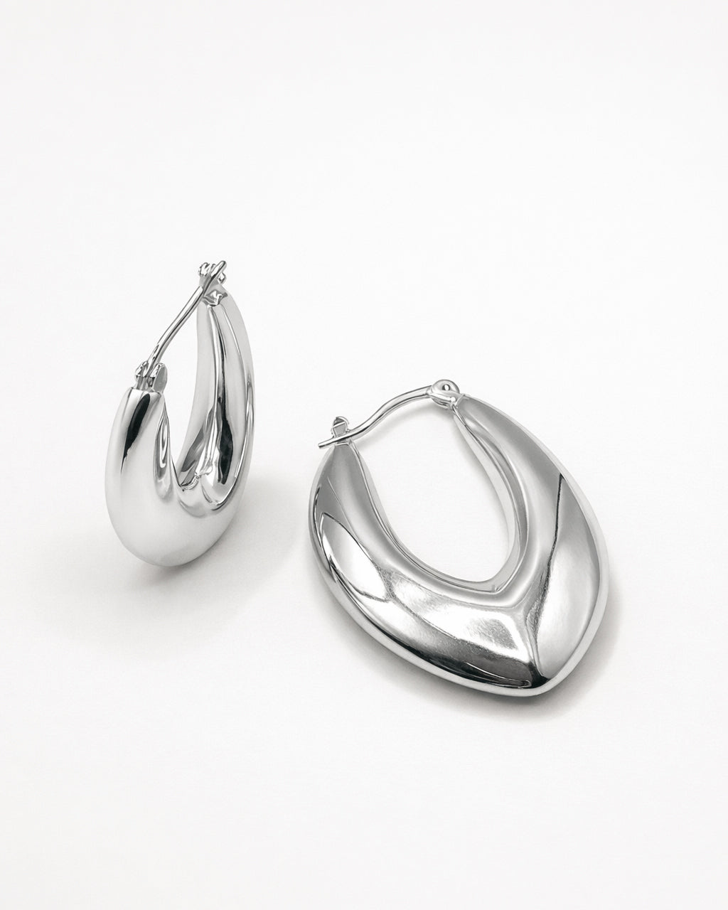 Silver sculpted hoop earrings top view, featuring a marquise-inspired shape and polished minimalist design by Jadejuri