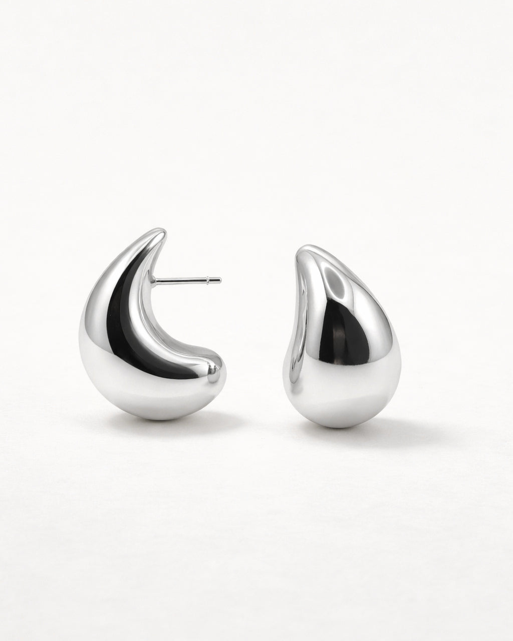 Silver sculpted teardrop stud earrings front view, featuring a polished minimalist design by Jadejuri