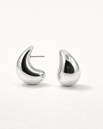 Silver sculpted teardrop stud earrings front view, featuring a polished minimalist design by Jadejuri