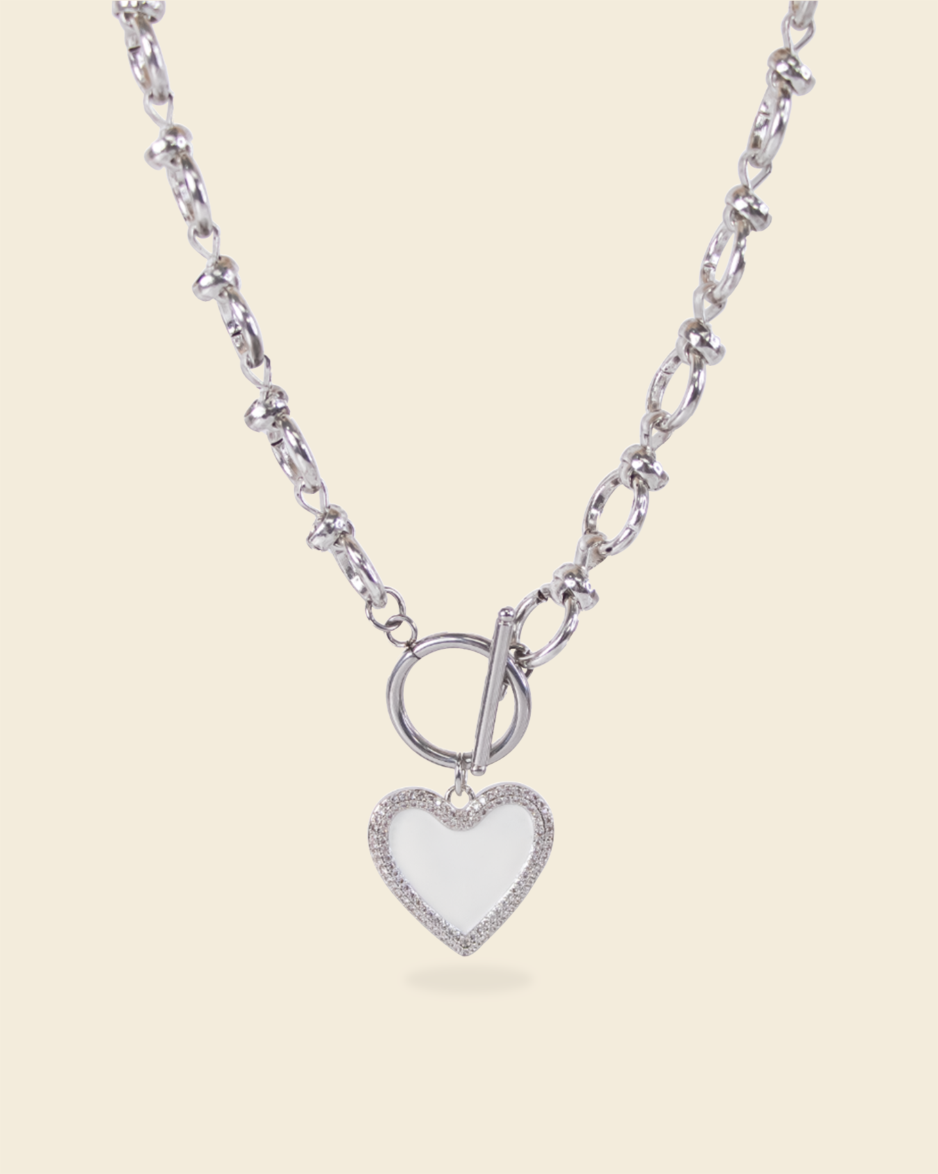 Silver necklace with textured chain and white heart enamel pendant – toggle clasp design with pavé detailing.