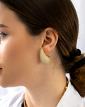 gold teardrop stud earrings paved with shimmering zircon stones close up model side