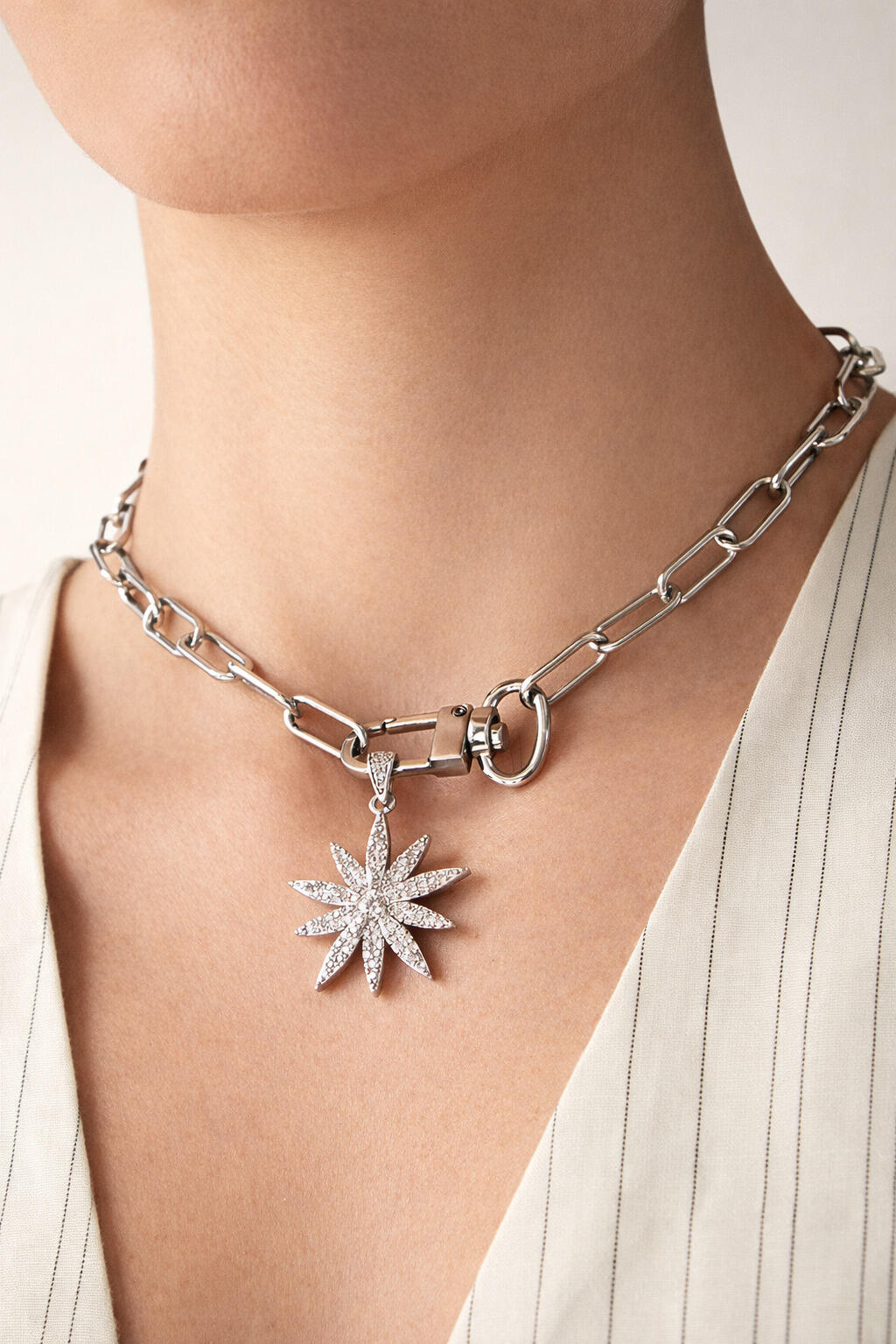 18k gold-plated starburst lock choker necklace worn on model, bold chain choker with star pendant