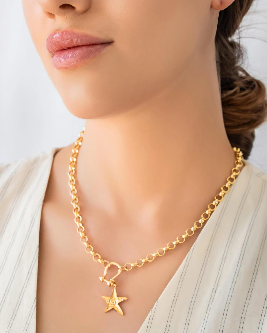 Gold star pendant chain necklace worn on model, featuring a chunky gold chain and star charm necklace by Jadejuri