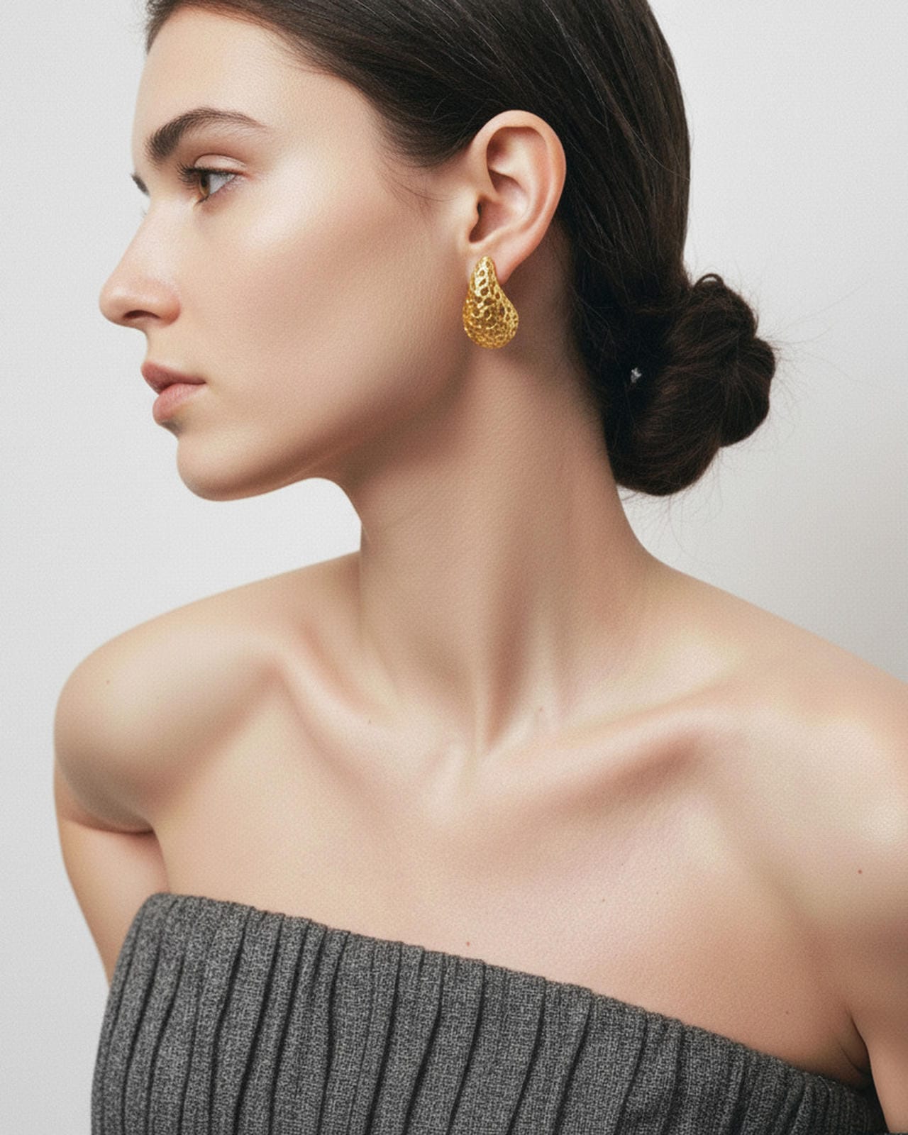 18K gold-plated teardrop stud earrings worn on model, textured sculptural design with elegant shine