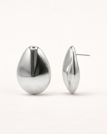Silver sculpted teardrop stud earrings front view, featuring a smooth polished minimalist design by Jadejuri
