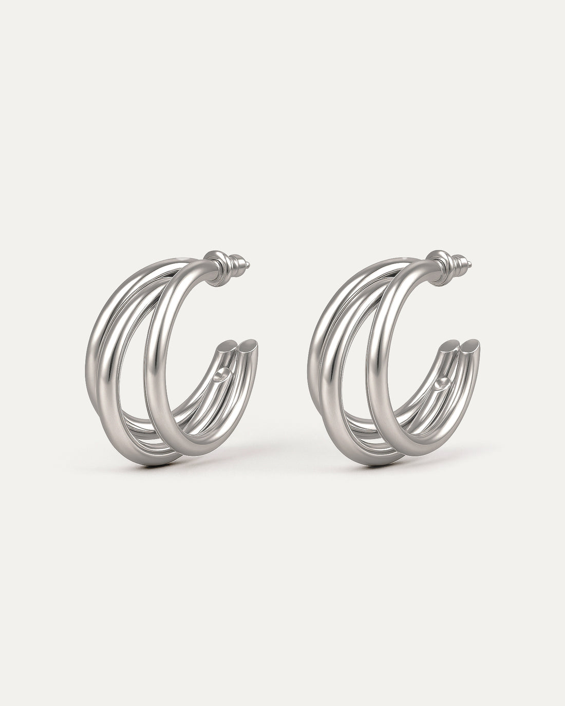Silver-plated brass triple C-shaped hoop earrings with sleek modern design on white background