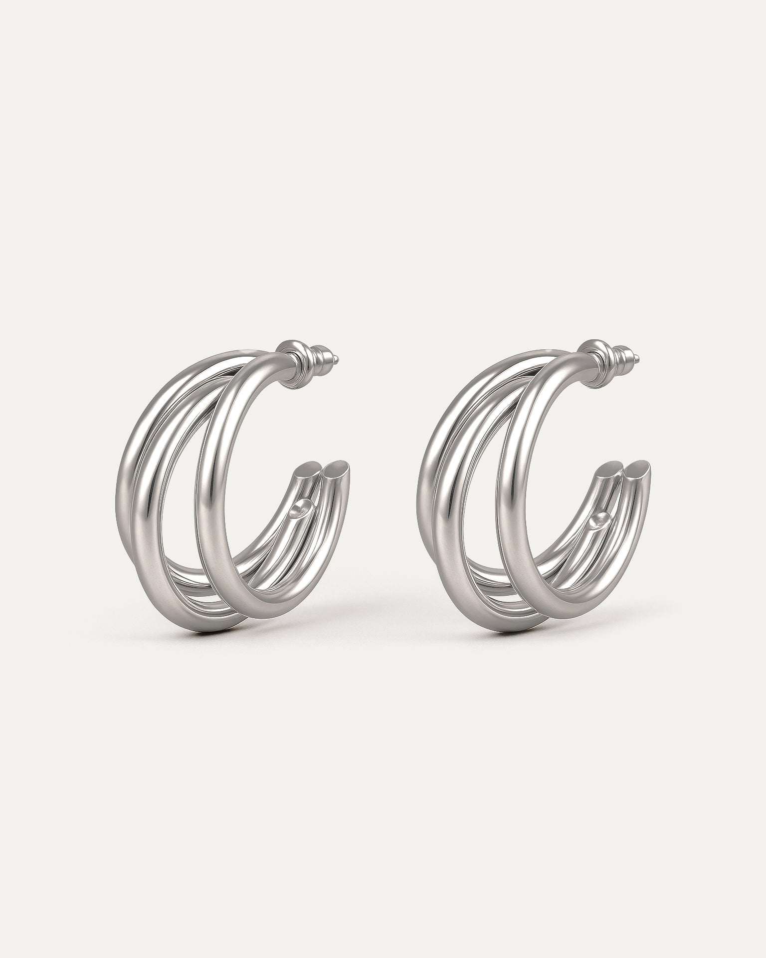 Silver-plated brass triple C-shaped hoop earrings with sleek modern design on white background