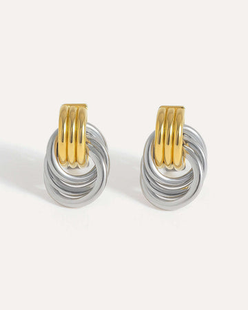 Pair of silver and gold hoop earrings on a white background