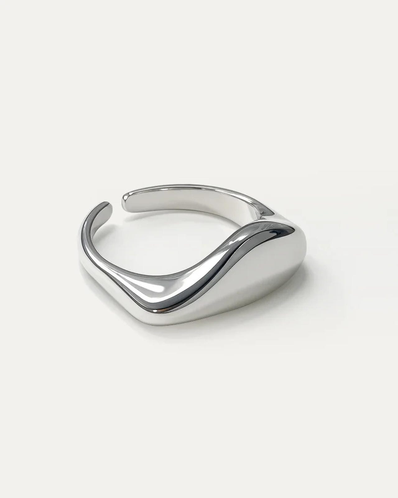 Wavecrest Ring – adjustable silver-plated brass minimalist ring by Jadejuri, sleek sculpted wave-inspired design.