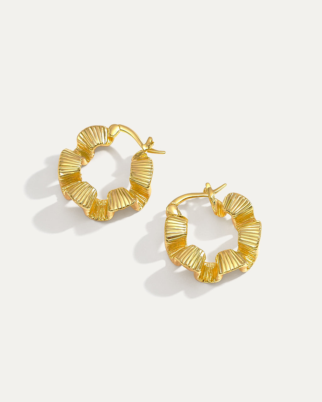 18K gold-plated brass hoop earrings with wavy petal-inspired design on white background